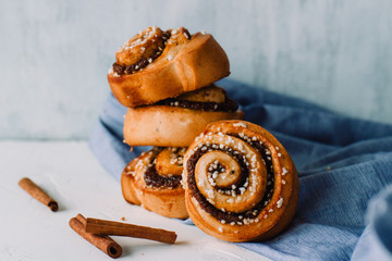Cinnamon roll, traditional scandinavian christmas recipe on a white rustic background