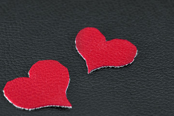 two red hearts on black skin