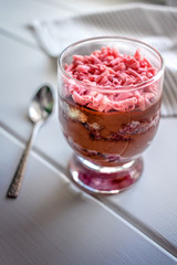 Trifle on a white table with a spoon