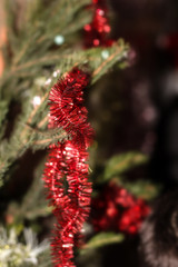 Christmas background with green spruce branches and red rain