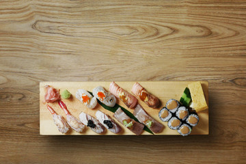 Sushi Nigiri set on wooden plate with wood background 