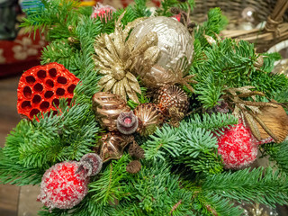 Composition of fir branches, berrries, flower, baubles and balls. Christmas and New Year background