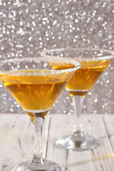 Two glasses with a yellow cocktail