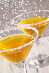 Two glasses with a yellow cocktail