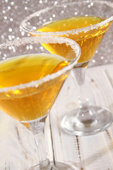 Two glasses with a yellow cocktail