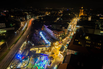 Aerial night view of a christmas market in germany, church in background
