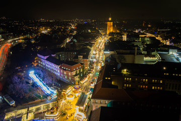 Aerial night view of a christmas market in germany, church in background