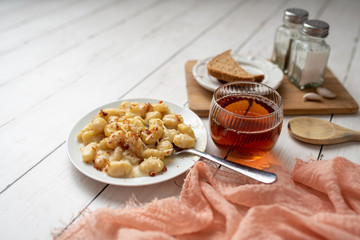 Cheese gnocchi with cheese sauce and bacon bits for garnish on top