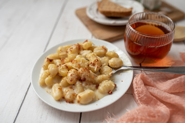 Cheese gnocchi with cheese sauce and bacon bits for garnish on top