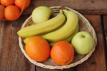 Oranges apples and bananas on the table 