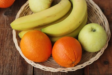 Oranges apples and bananas on the table 