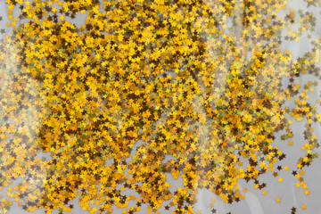 Gold sparkle glitter background. Glittering sequins stars wall.