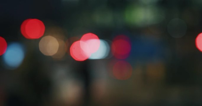 Slow motion of blurred lights of busy traffic in a monopoly city center.Shot in 8K. Concept of cityscape,urban traffic, monopoly
