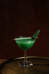 Kiwi and prosecco cocktail. In alternative with Champagne and vodka. Garnished with sage leaf