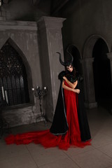 girl in a witch costume with horns