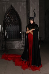 Fototapeta na wymiar girl in a witch costume with horns