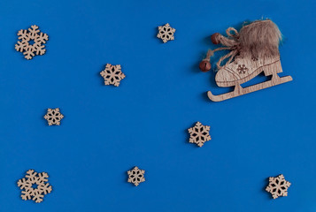 Christmas composition. Skates and snowflakes on a blue background. Flat lay, copy space, new year, top view, minimal.
