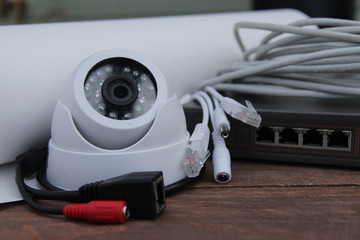 CCTV camera on the table with drawings and equipment for building a security system