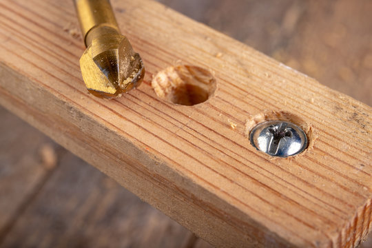Drilling holes in a piece of wood. Countersinking the hole for wood screws.