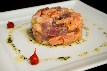 sushi hashi sauce on white plate shoyu raw salmon and sesame pepper
