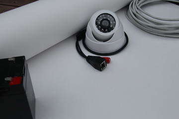 CCTV camera on the table with drawings and equipment for building a security system