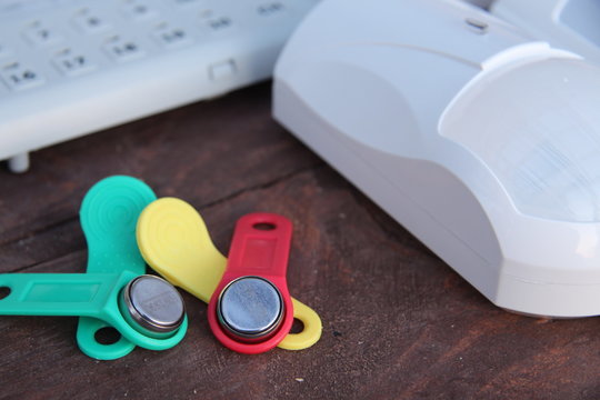 iButton Touch Memory keys in different colors on the table with equipment and sensors for security and security