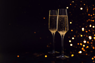 Glasses of champagne with black background and lights © Mary
