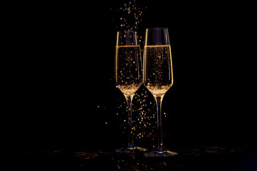 Glasses of champagne with black background and lights