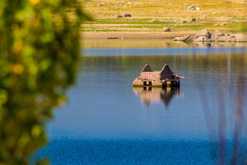 Low water lake showing an old house