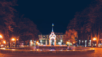 Fototapeta na wymiar Mirror stream in winter - the first symbol of the city Kharkov, a fountain in the heart of the city illuminated by night