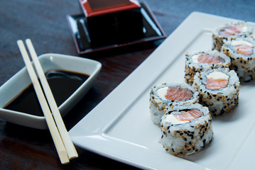 Uramaki Philadelphia Salmon and Cream Cheese	on a white plate, asian food, japanese cuisine