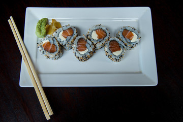 Uramaki Philadelphia Salmon and Cream Cheese	on a white plate, japanese food, top view, asian food, japanese cuisine