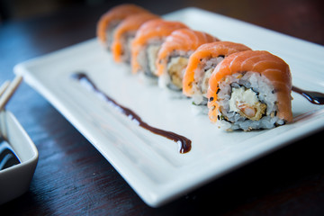 Rainbow roll on white plate, asian food, japanese cuisine
