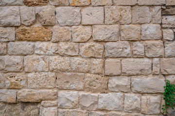 Gray old stone wall background. yellow rock wall made of stone.