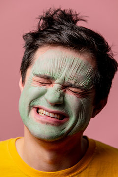 beautiful brunette man with algae mask on his face