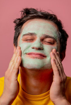 beautiful brunette man with algae mask on his face