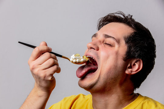 Man eats a pills with spoon