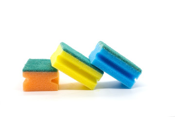 Three multi-colored sponges for washing dishes on a white background
