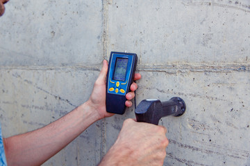 A person examines the concrete and determines the properties, density and quality of the finished...