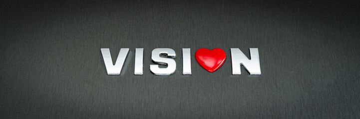 Word vision spelled with chrome letters in a conceptual image with red heart replacing letter o