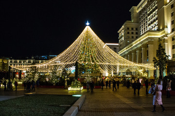 Christmas tree with illumination at night on Okhotny Ryad in Moscow Russia