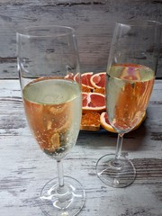  close-up of champagne glasses with blur / bokeh effect, on the background of sliced ​​grapefruit and sandwiches with red caviar on a blue plate