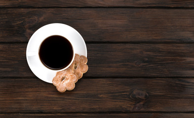 cup of coffee with cookies on a wooden background