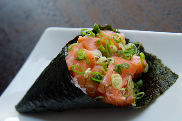 temaki cone-shaped sushi with raw salmon, asian food, japanese cuisine