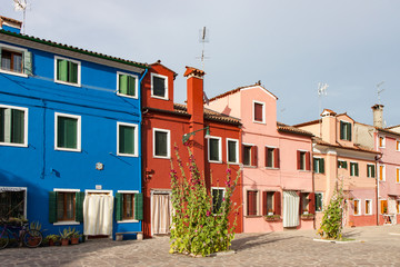 Fototapeta na wymiar Bright Colorful Buildings of Blue Red and Pink in Murano Italy