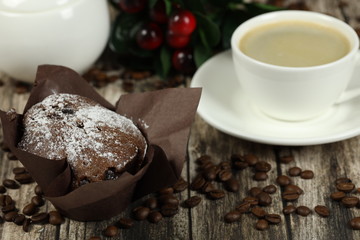 cup of coffee and muffin on a wooden table. Coffee time