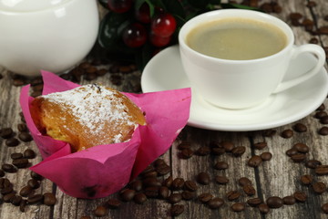 cup of coffee and muffin on a wooden table. Coffee time