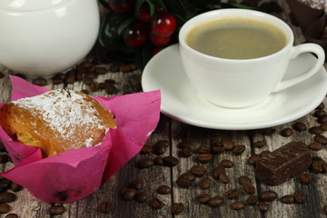 cup of coffee and muffin on a wooden table. Coffee time