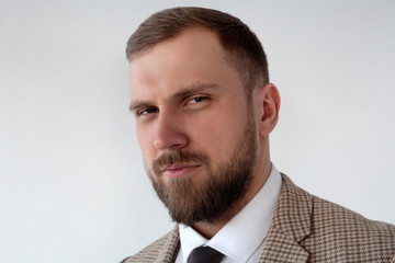 Male model in white shirt and red tie, black jacket and trousers, athletic build, isolated on a white background. The concept of classic clothes or office style.
