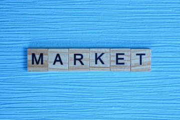 word market made of small wooden letters on a light blue paper background